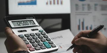 Calculating Universal Credit 2026 increase on a calculator with financial documents